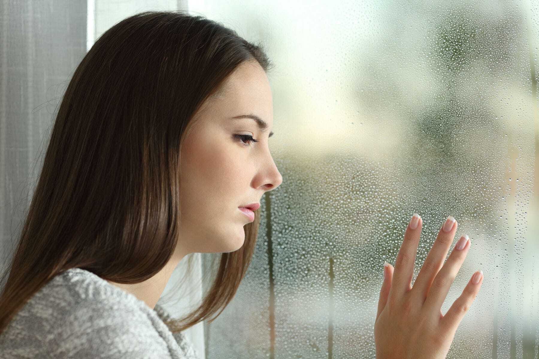 Upset woman looking out of the window