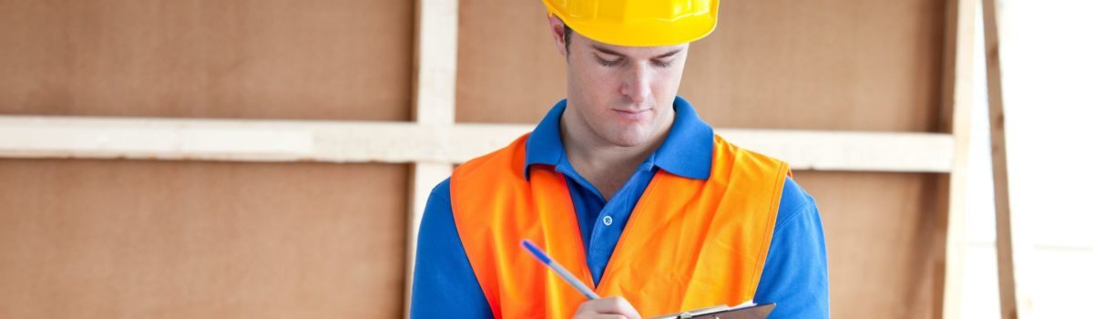 Construction worker checking his PPE checklist Construction worker checking his PPE checklist