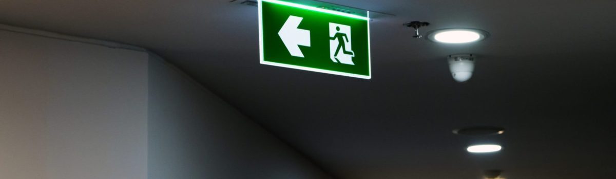 Florescent Emergency exit signs displayed in office Florescent Emergency exit signs displayed in office